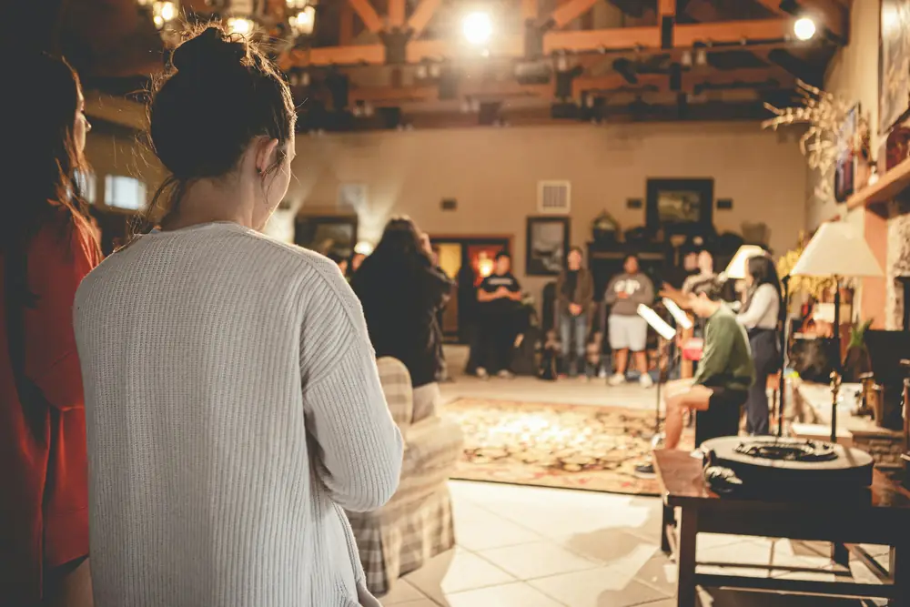 People gathered together in a warmly lit room