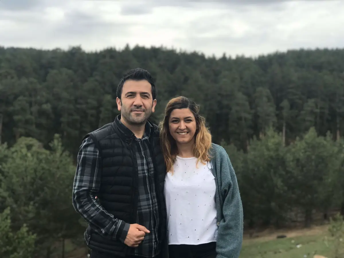 Ekrem, Kars church leader, with his wife in a pine forest